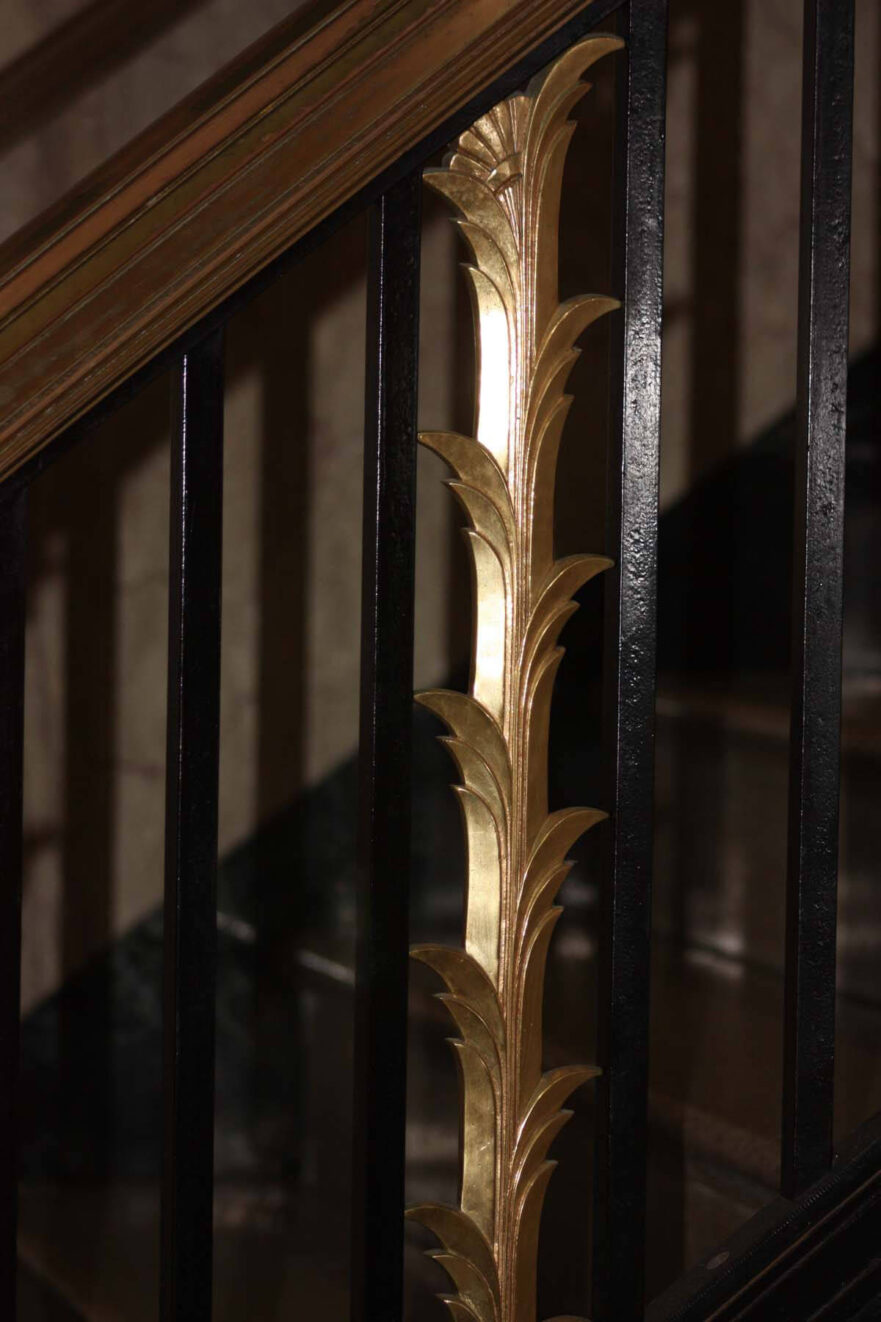 First floor railing with sheaf of wheat detail.