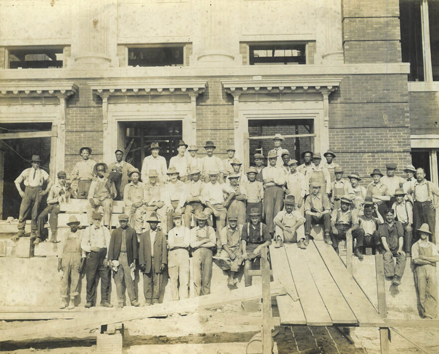 Craftsmen in front of practically complete Hammond High School, 1916