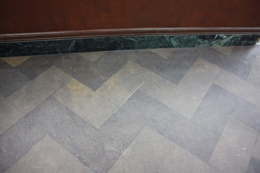 Marble courtroom floor laid in a herringbone pattern.