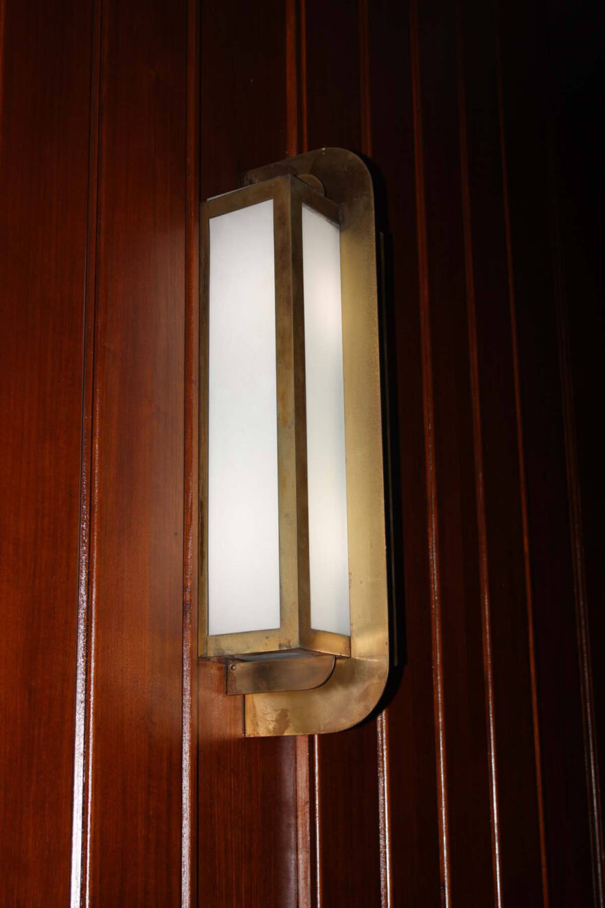 Original brass and glass wall sconce in the courtroom.