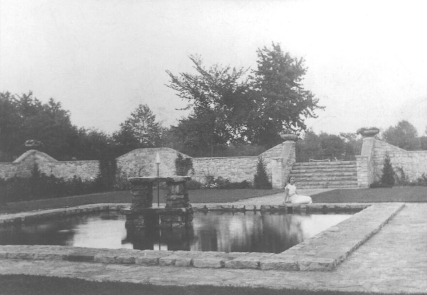 Girl reclining by pond in City Hall Park, circa 1941.