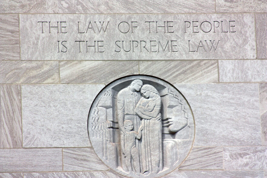 Inscription over the east entrance to City Hall, circa 2022.