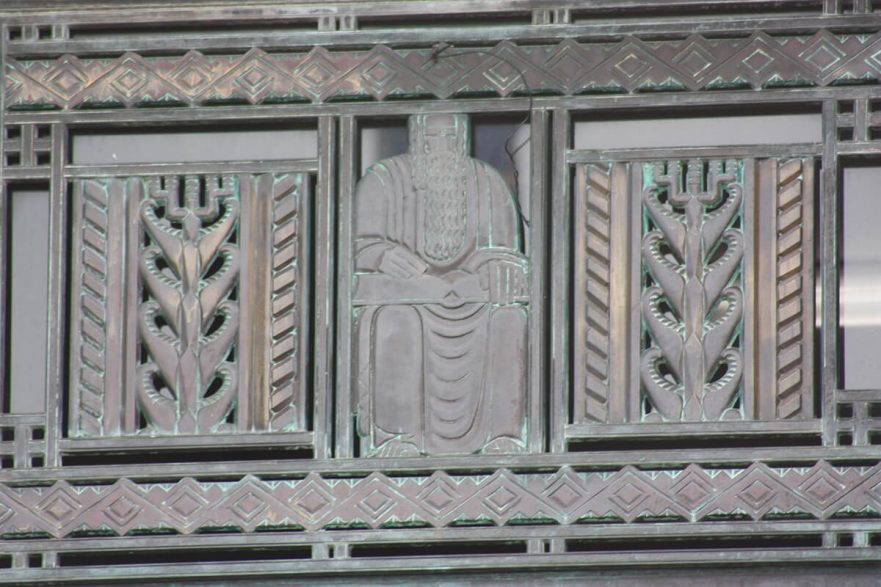 Bronze transom grates over the three main doors to City hall sculpted in the Art Deco style, circa 2022.